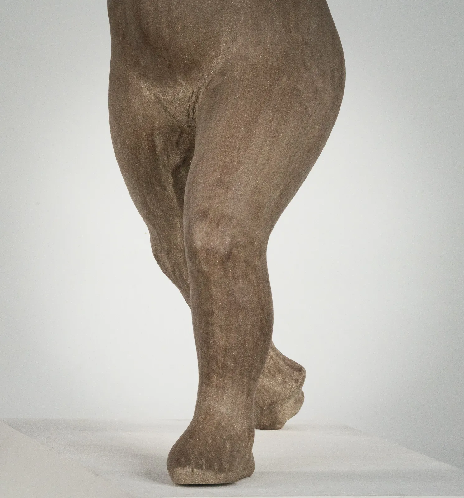 Figurative ceramic sculpture by artist Emilio DiIorio. Female figure is No. 3 in artist's The Dance series in gray clay.