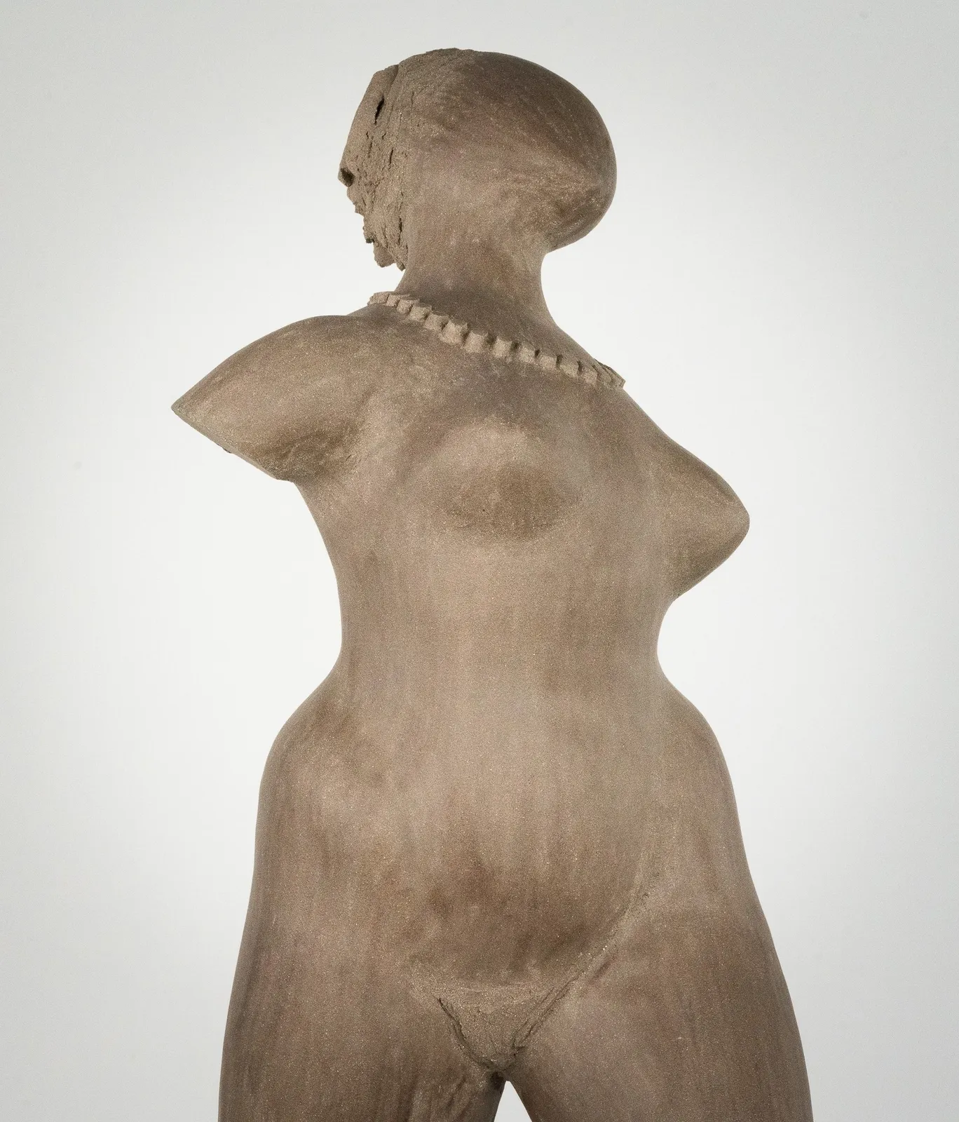 Figurative ceramic sculpture by artist Emilio DiIorio. Female figure is No. 3 in artist's The Dance series in gray clay.