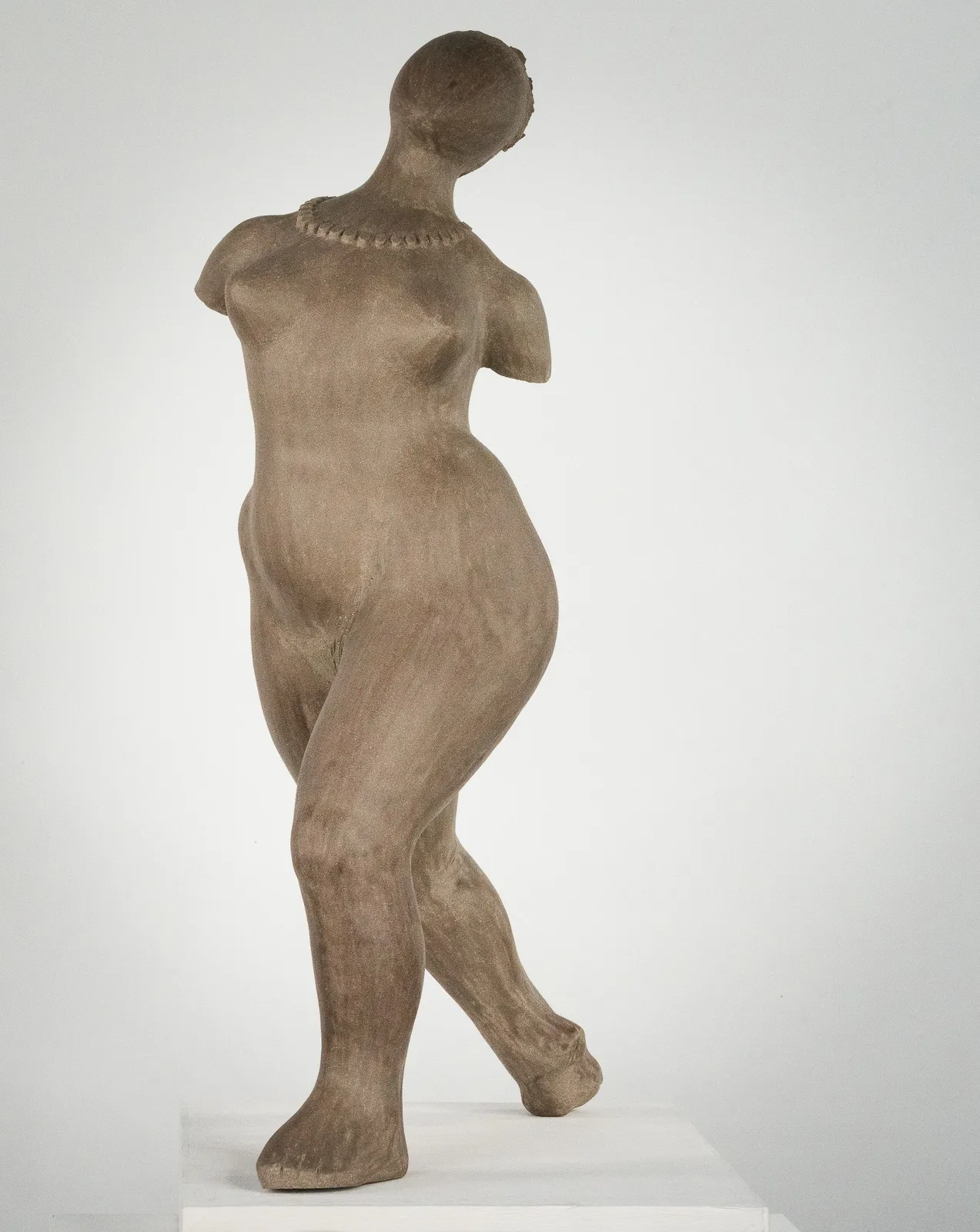 Figurative ceramic sculpture by artist Emilio DiIorio. Female figure is No. 3 in artist's The Dance series in gray clay.
