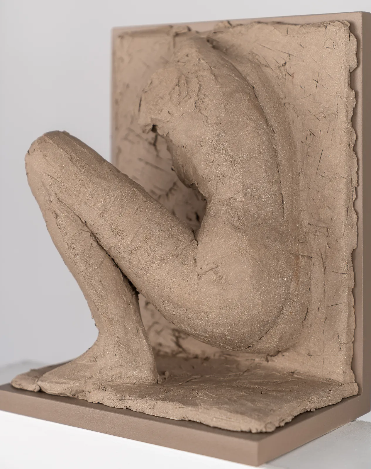 Figurative ceramic relief by artist Emilio DiIorio in Women of Troy series in gray clay.