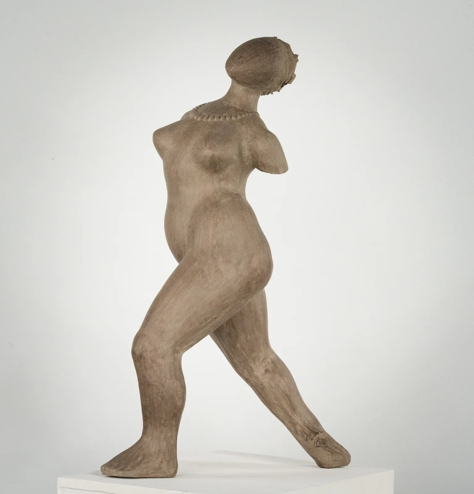 Figurative ceramic sculpture by artist Emilio DiIorio. Female figure is No. 3 in artist's The Dance series in gray clay.