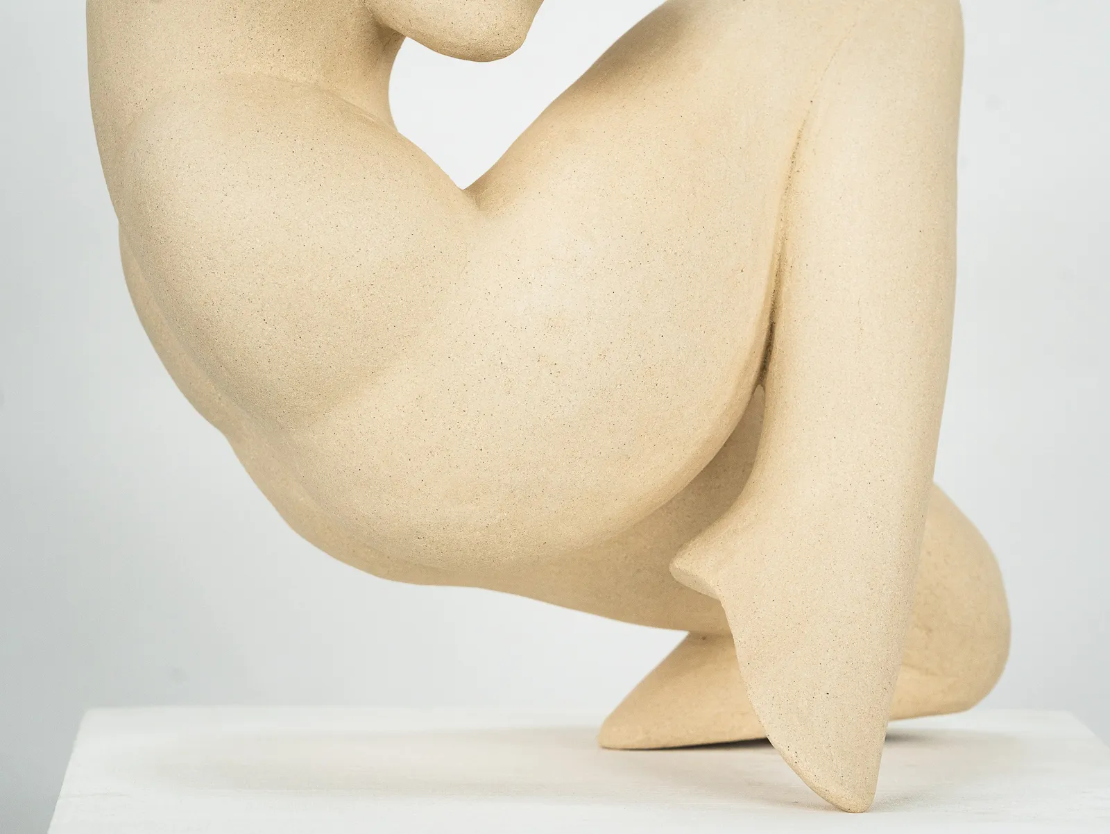 Figurative sculpture in white clay by artist Emilio DiIorio. Crouching figure is No. 2 in artist's Fragmented Aphrodite series.