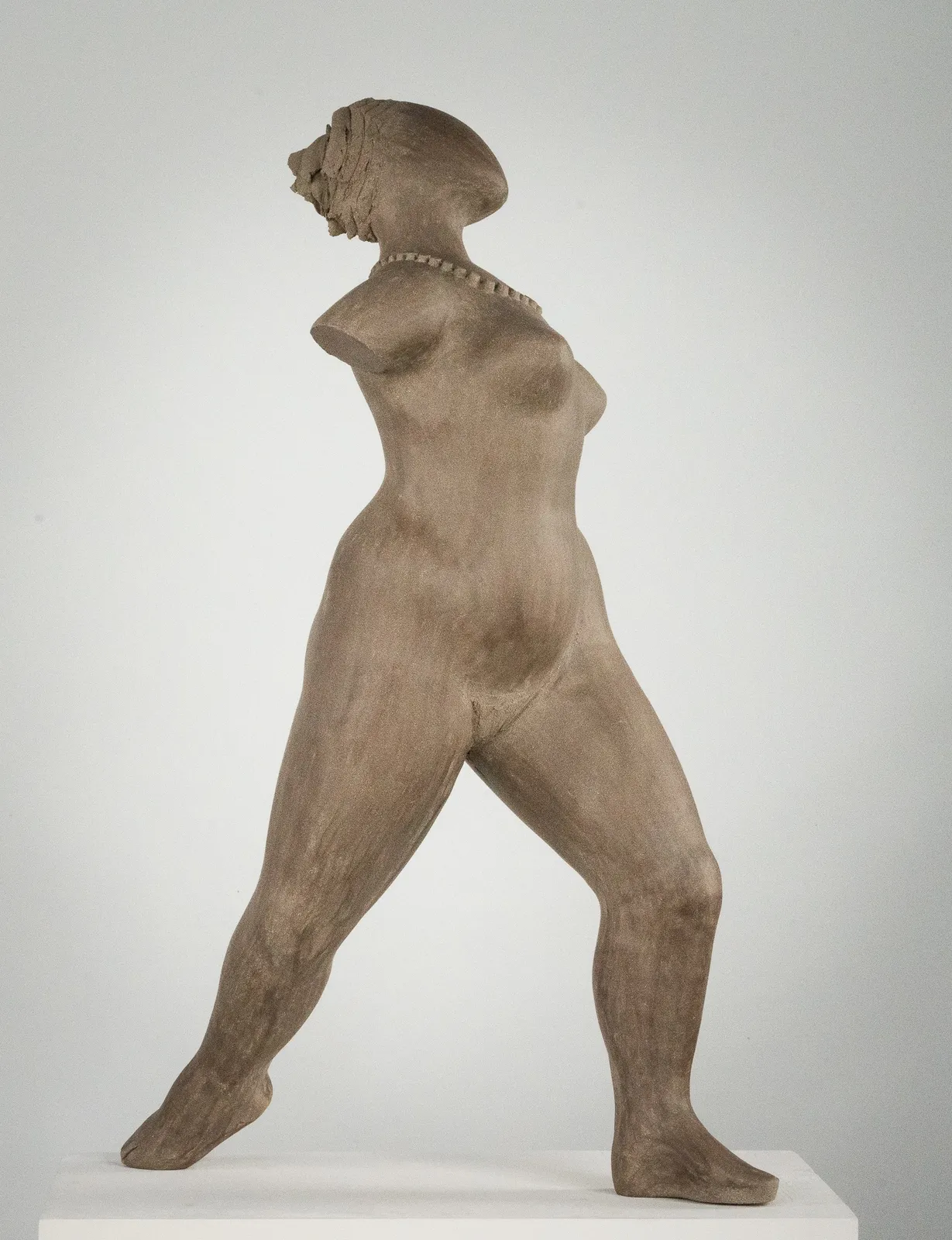 Figurative ceramic sculpture by artist Emilio DiIorio. Female figure is No. 3 in artist's The Dance series in gray clay.