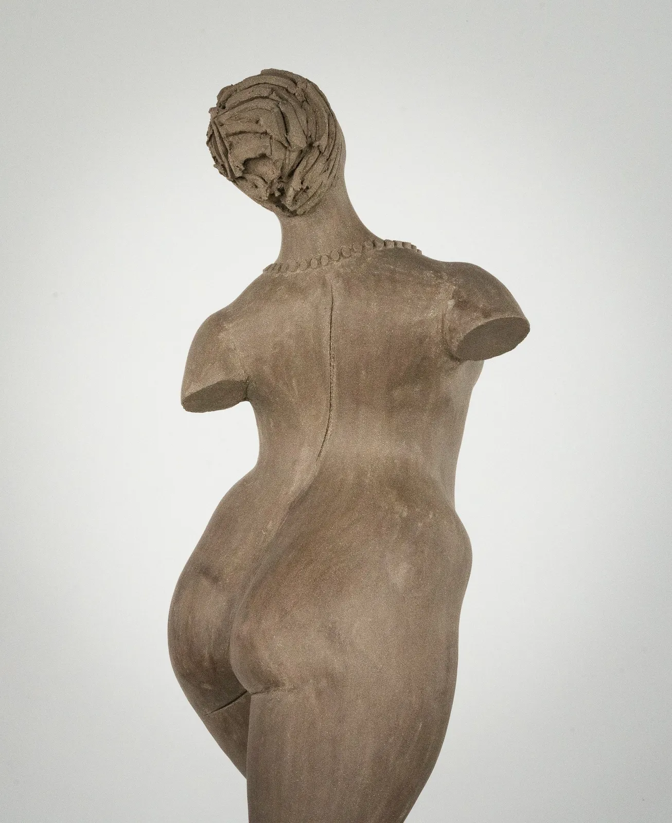 Figurative ceramic sculpture by artist Emilio DiIorio. Female figure is No. 3 in artist's The Dance series in gray clay.