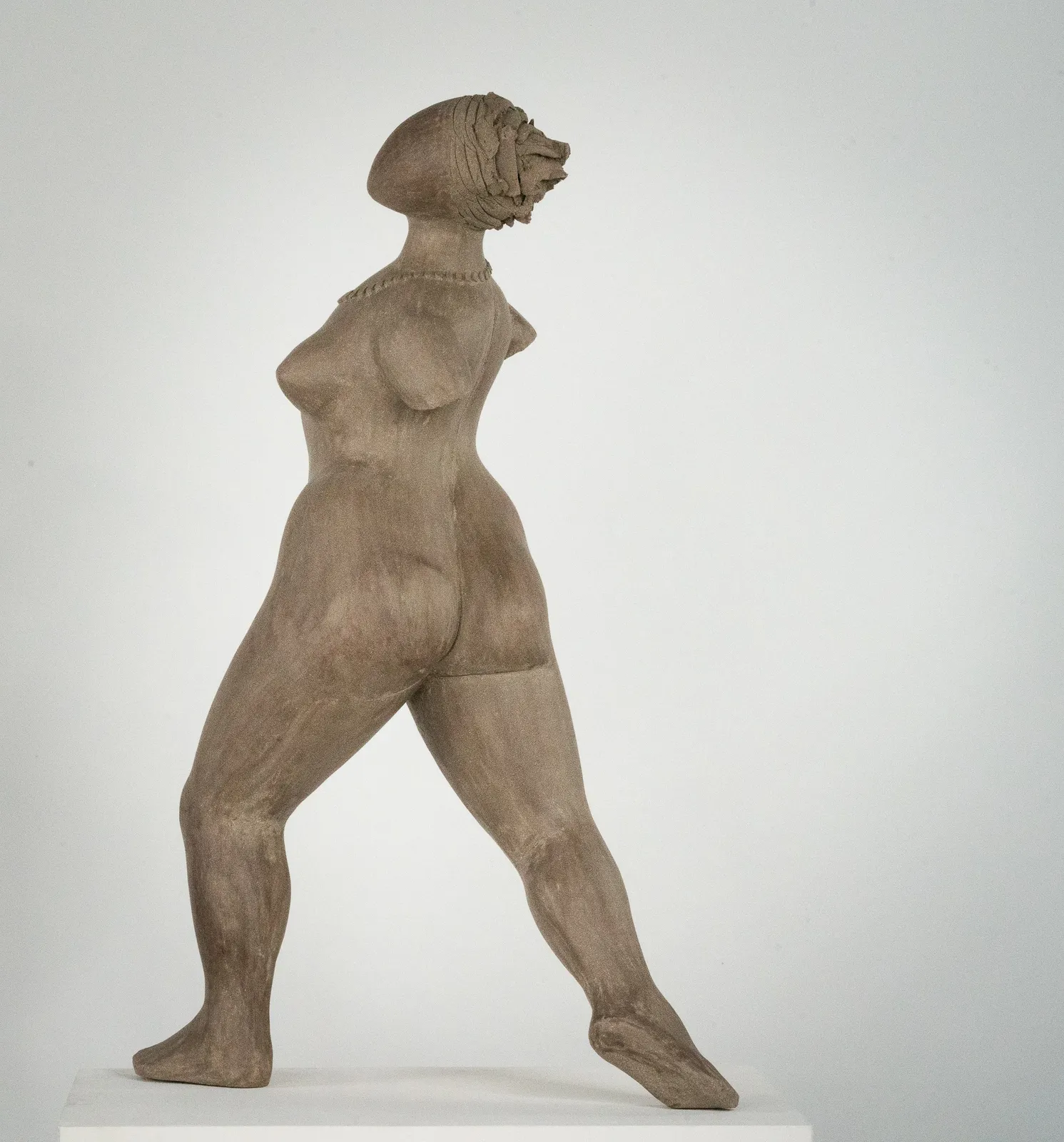 Figurative ceramic sculpture by artist Emilio DiIorio. Female figure is No. 3 in artist's The Dance series in gray clay.