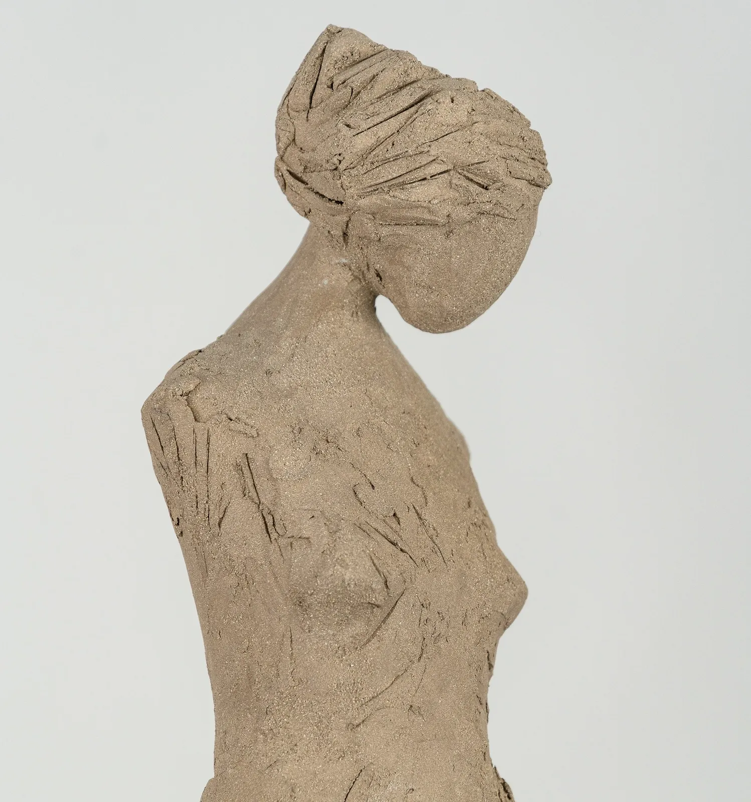 Fragmented figurative female torso in gray clay by sculptor Emilio DiIorio.