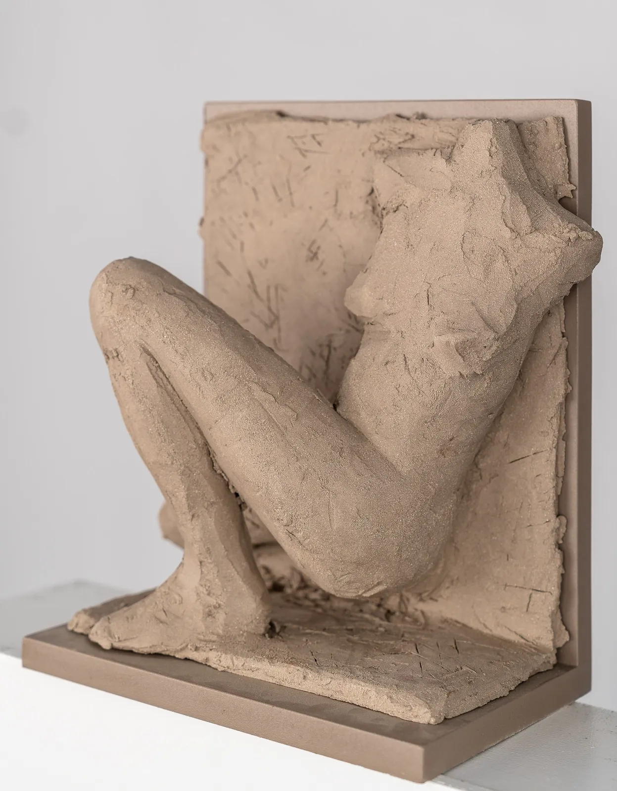 Figurative ceramic relief by artist Emilio DiIorio in Women of Troy series in gray clay.