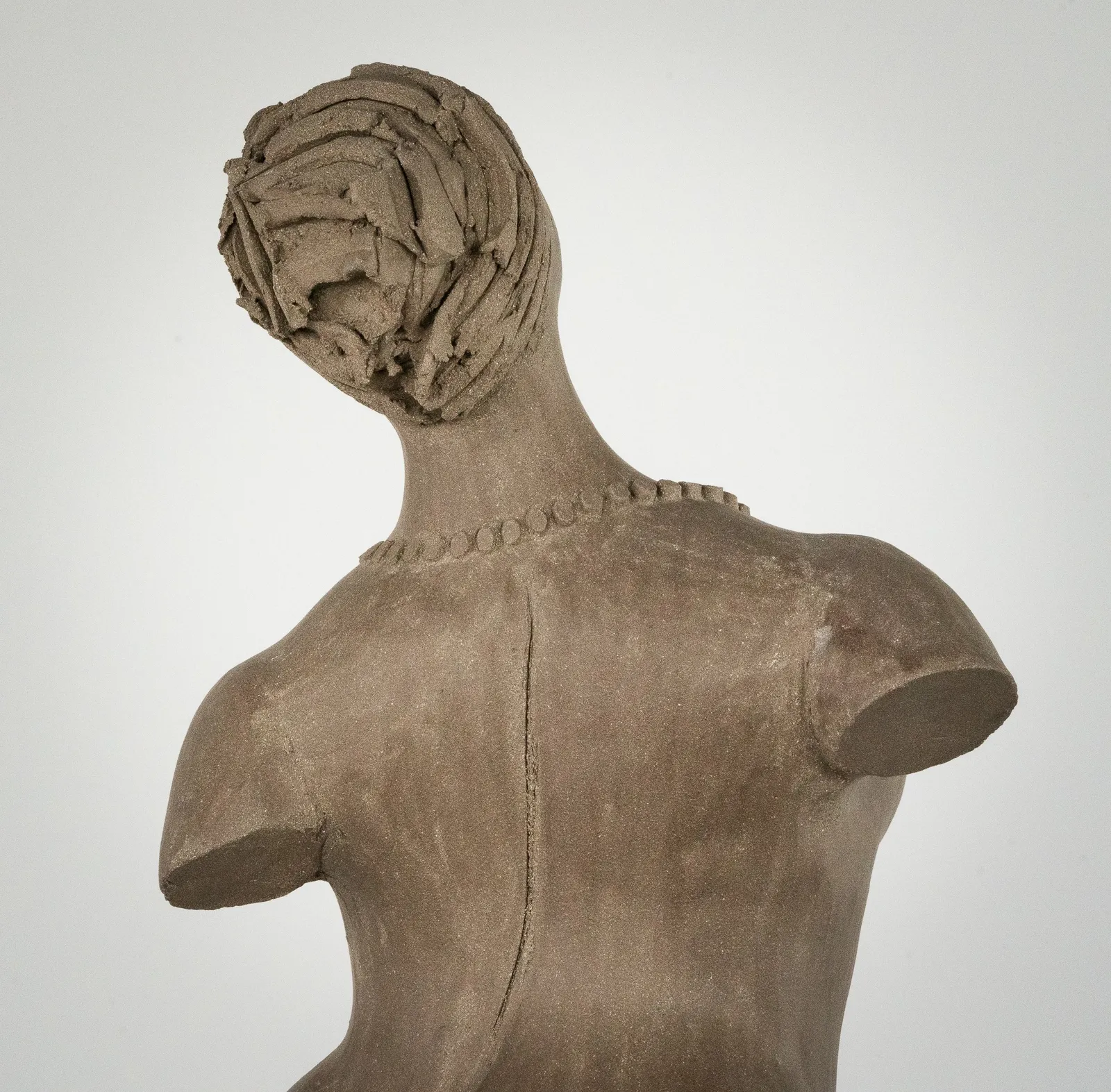 Figurative ceramic sculpture by artist Emilio DiIorio. Female figure is No. 3 in artist's The Dance series in gray clay.