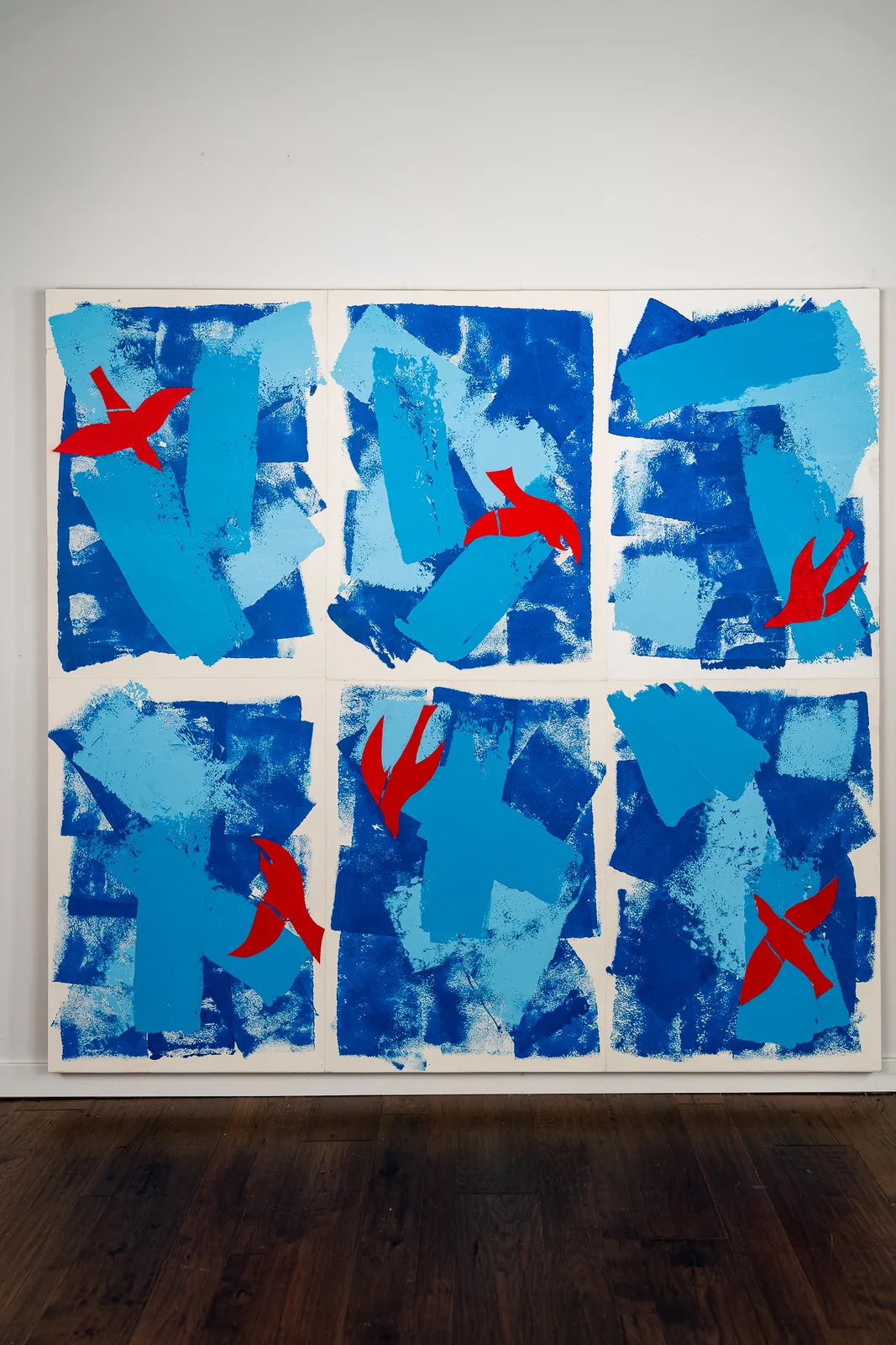 Abstract collage in shades of blue with red birds by artist Emilio DiIorio