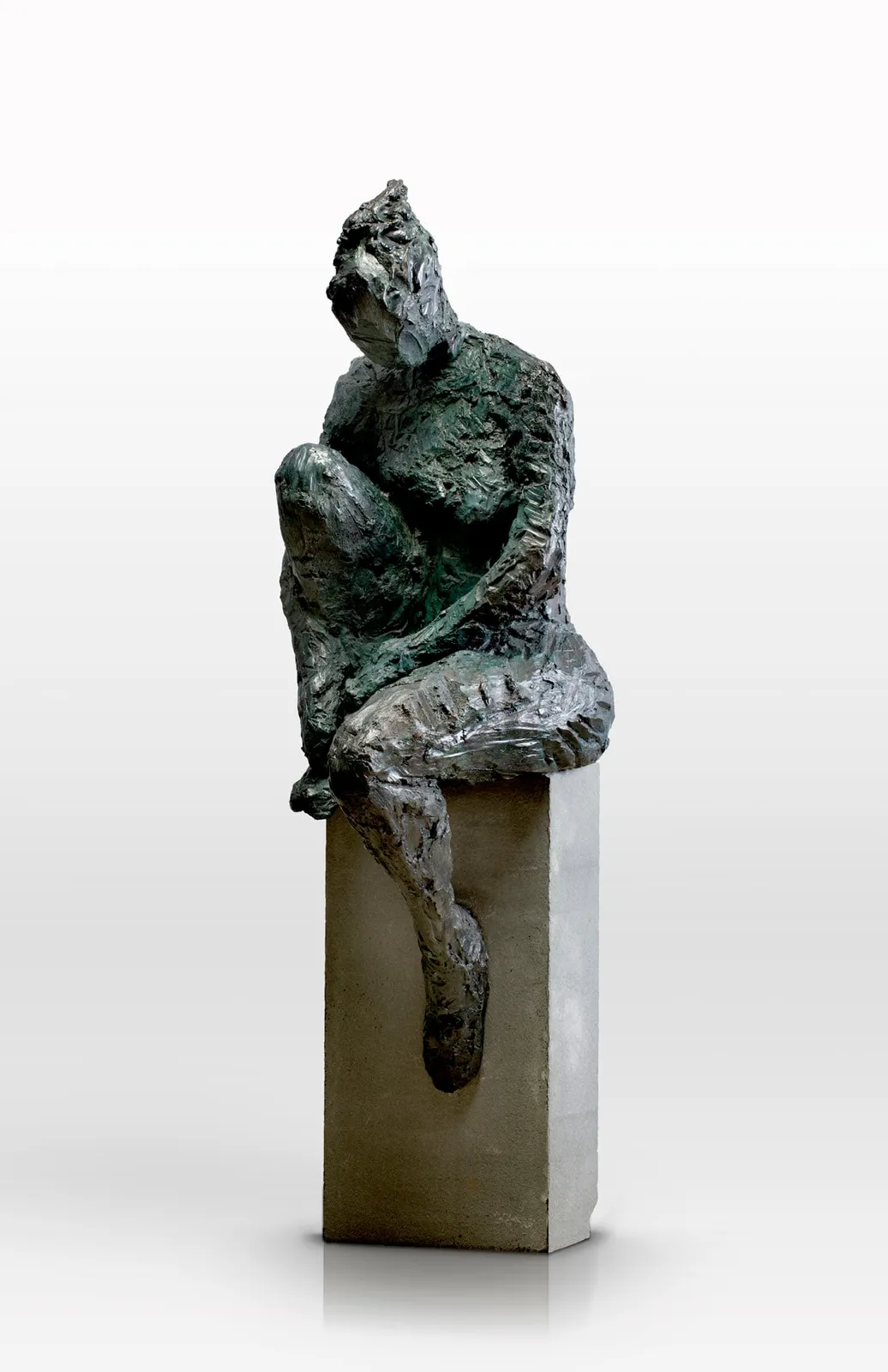 Bronze sculpture of female figure seated on bluestone by artist Emilio DiIorio.