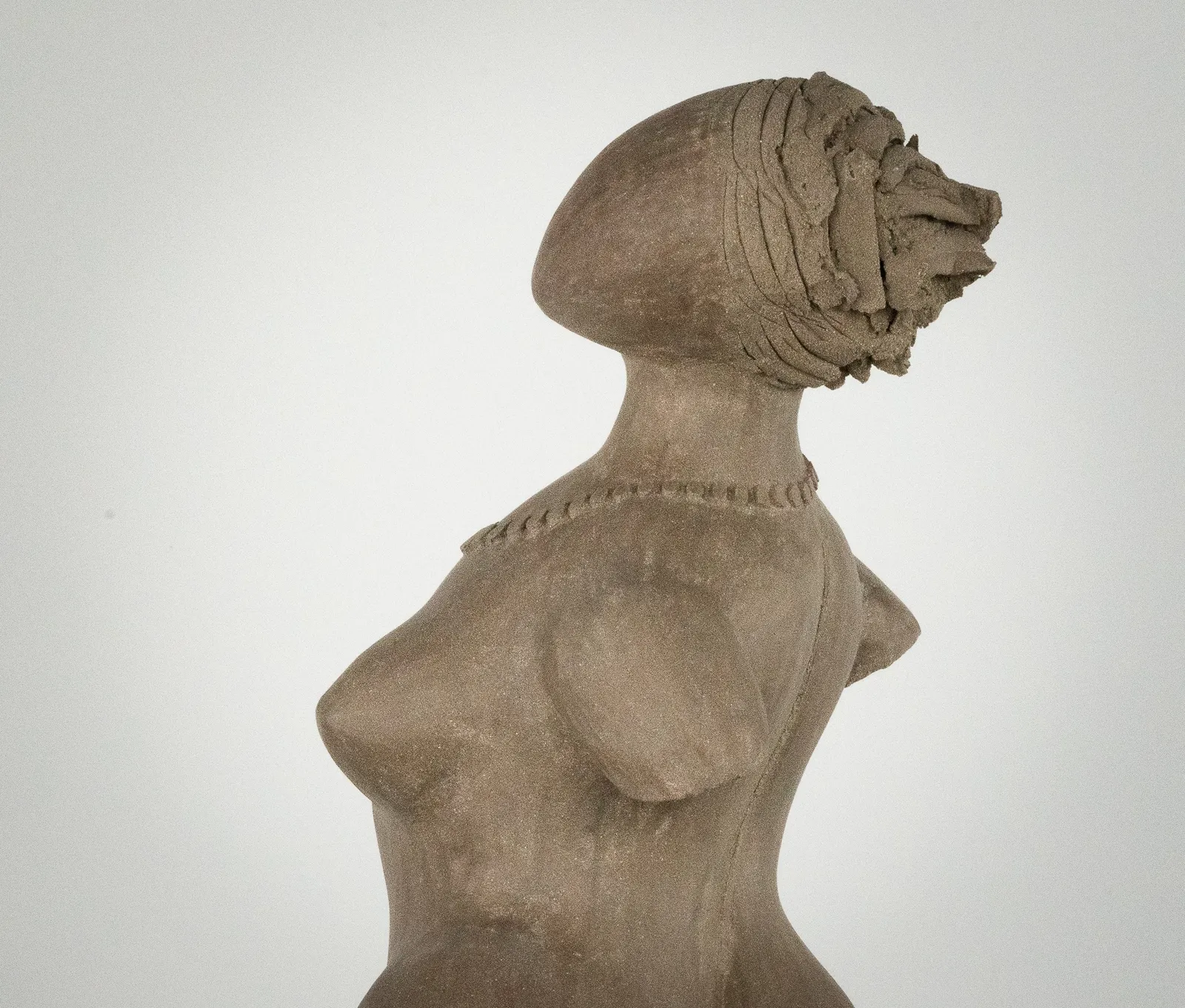 Figurative ceramic sculpture by artist Emilio DiIorio. Female figure is No. 3 in artist's The Dance series in gray clay.