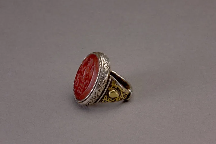 Oval silver Islamic ring with carnelian intaglio of a seated figure in profile to the right