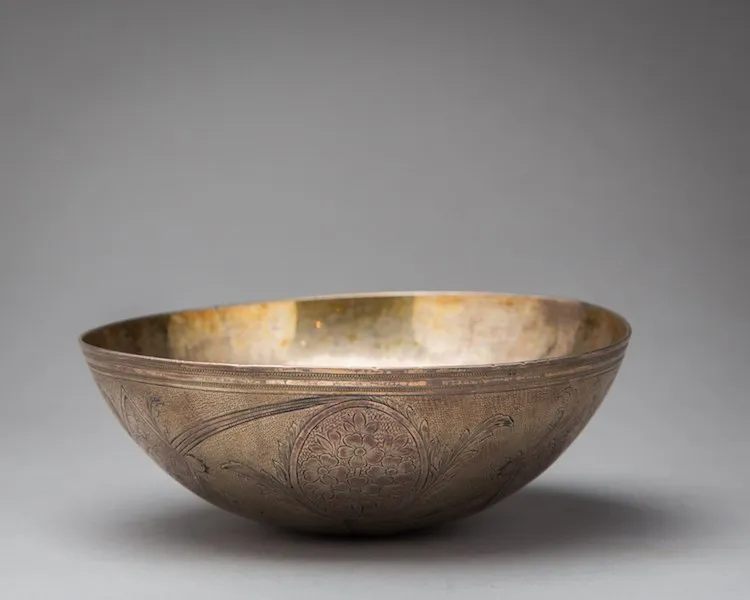 Silver hemispherical bowl with incised decorations