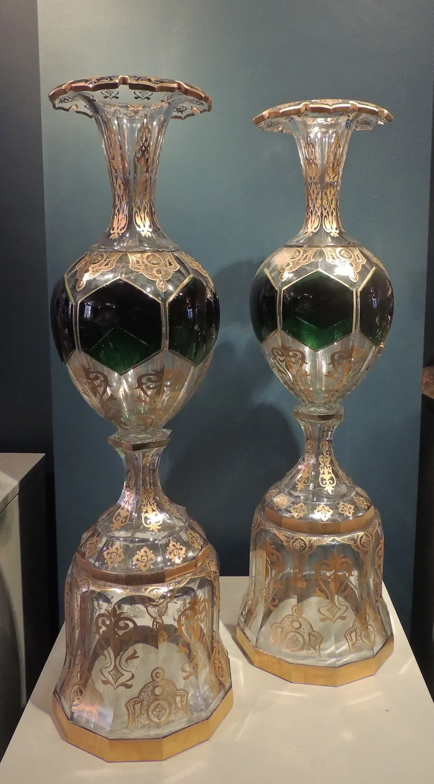 Pair of glass vases on pedestals, decorated in gold and green