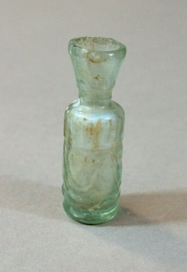 A Persian small light blue tubular flask with wheel-cut decoration, 12th Century CE