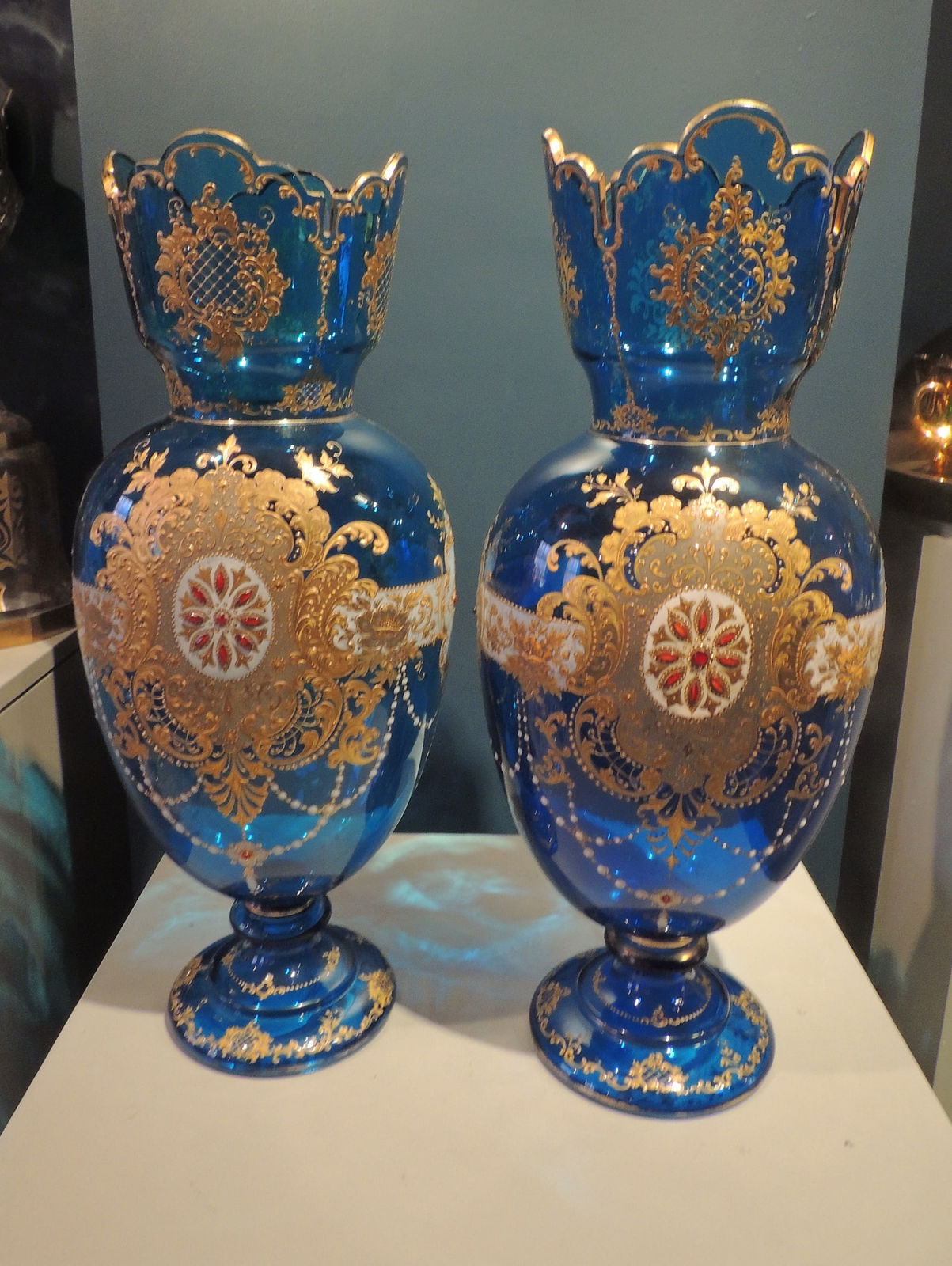 Pair of blue glass gilt and enamelled crenellated vases