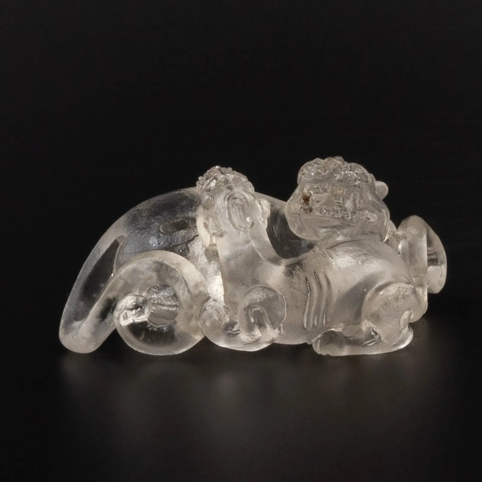 Cast glass figuring of two reclining mythological beasts, 1644-1912 CE