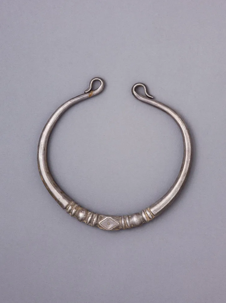 Silver torque decorated by abstract and linear engraving