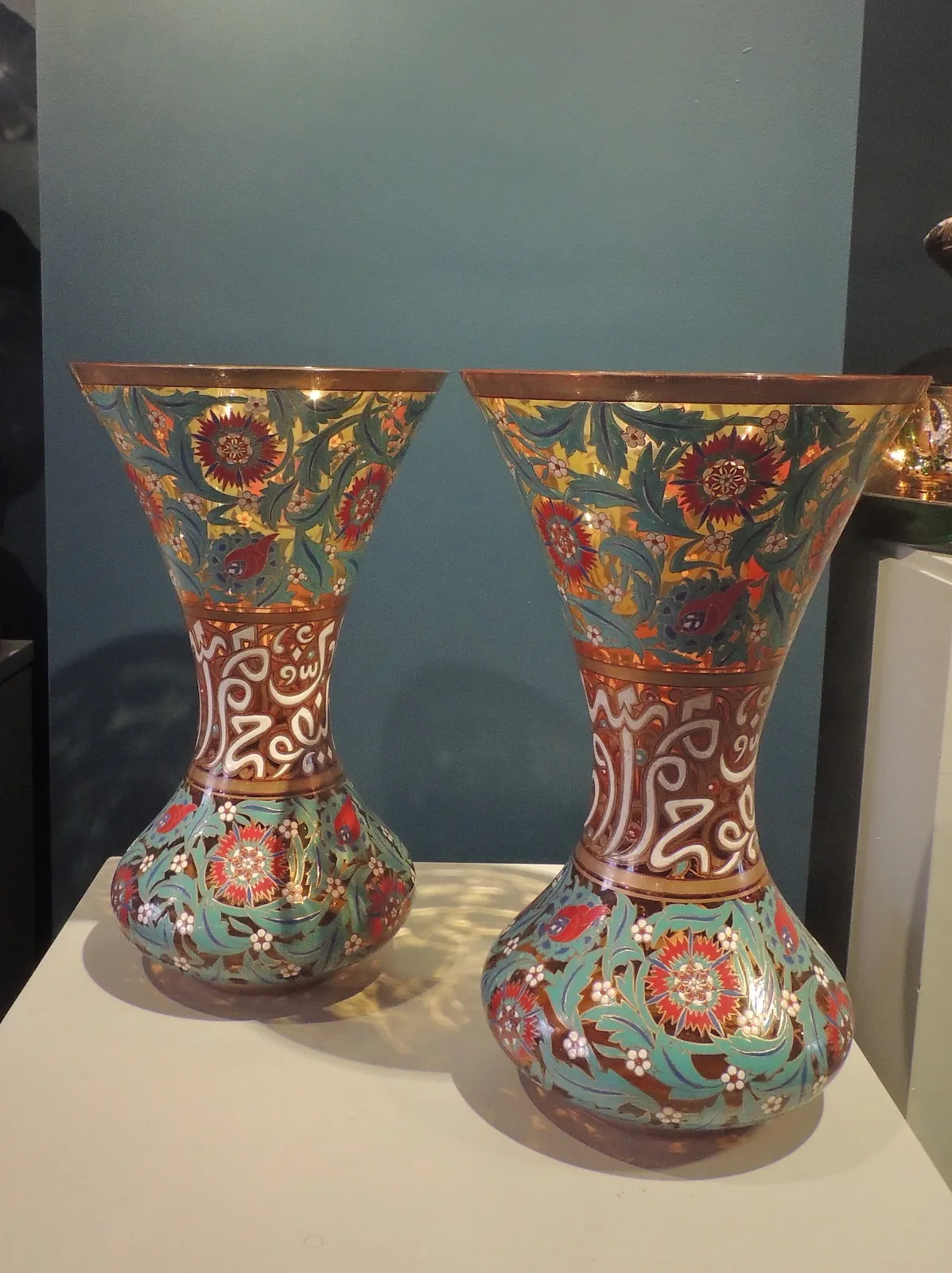 Pair of enamelled vases with floral decoration and islamic inscriptions