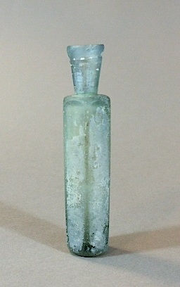 A light blue glass flask with faceted body, 12th Century CE