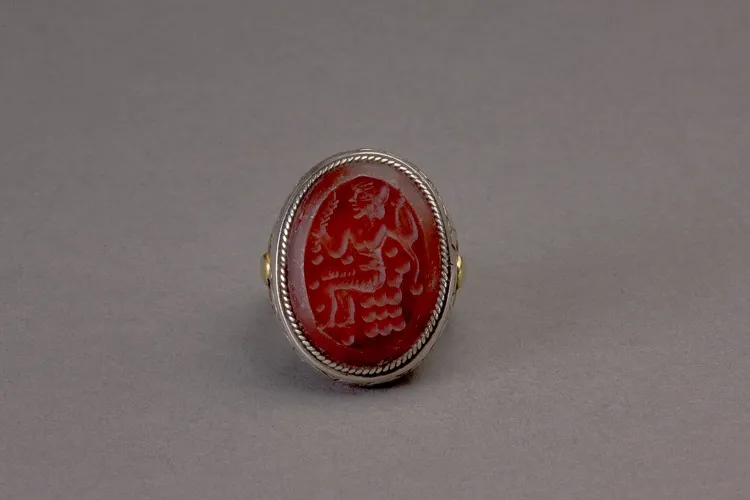 Oval silver Islamic ring with carnelian intaglio of a seated figure in profile to the right