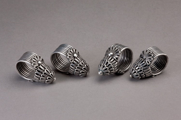 Four (4) silver bird-cage type Afghani rings