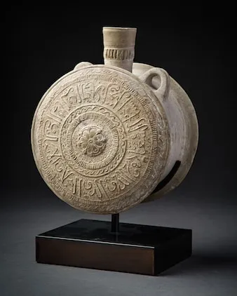 A Moulded Unglazed Terracotta Pilgrim Flask, 13th Century CE - 14th Century CE