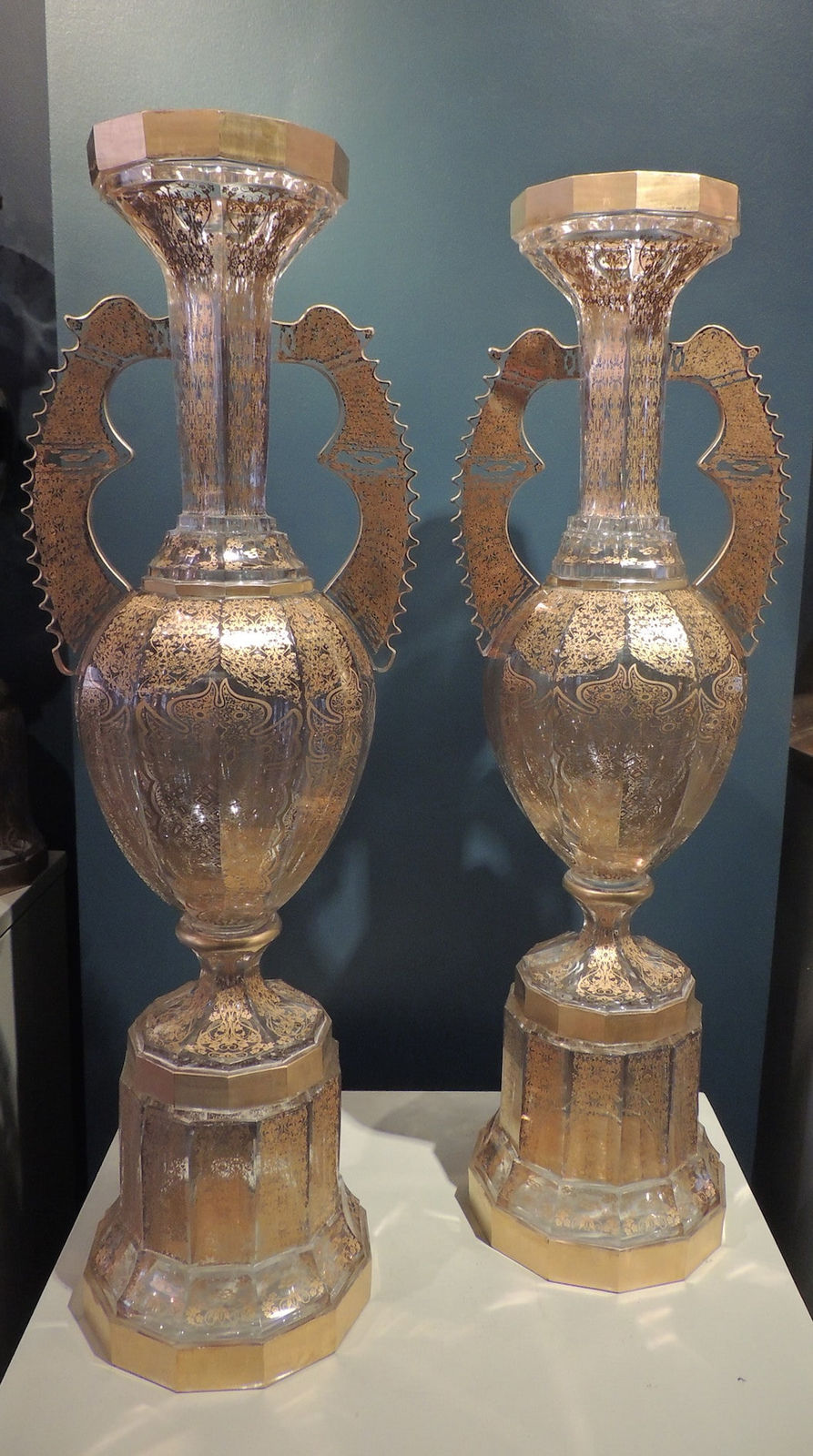 Pair of tall glass vases on stands