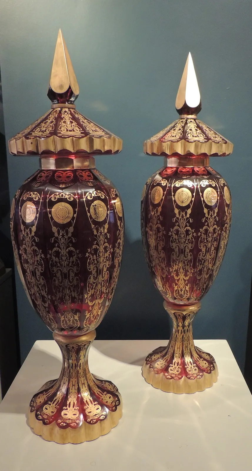 Pair of cranberry glass lidded vases