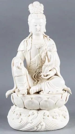 Blanc de Chine figure seated in a lotus flower, 19th Century CE