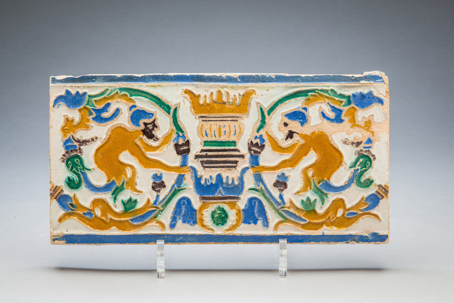 Spanish cuerda seca tile with floral elements and male bearded figures