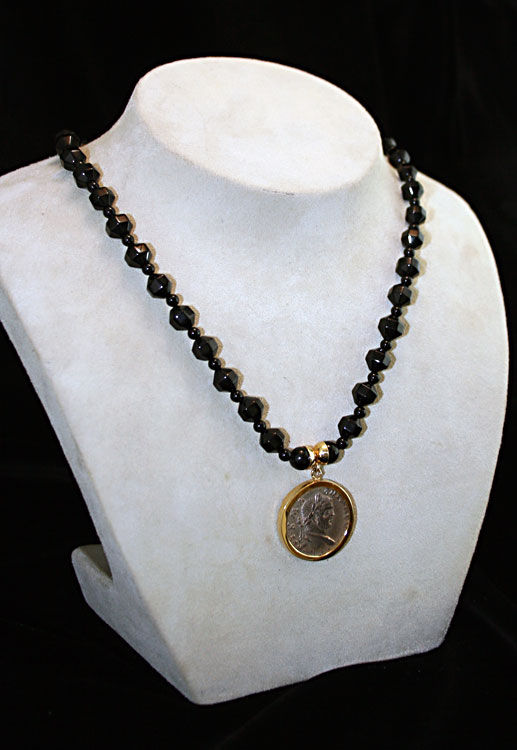 Tetradrachm of the Roman Emperor Caracalla in beaded necklace, 198 CE - 217 CE