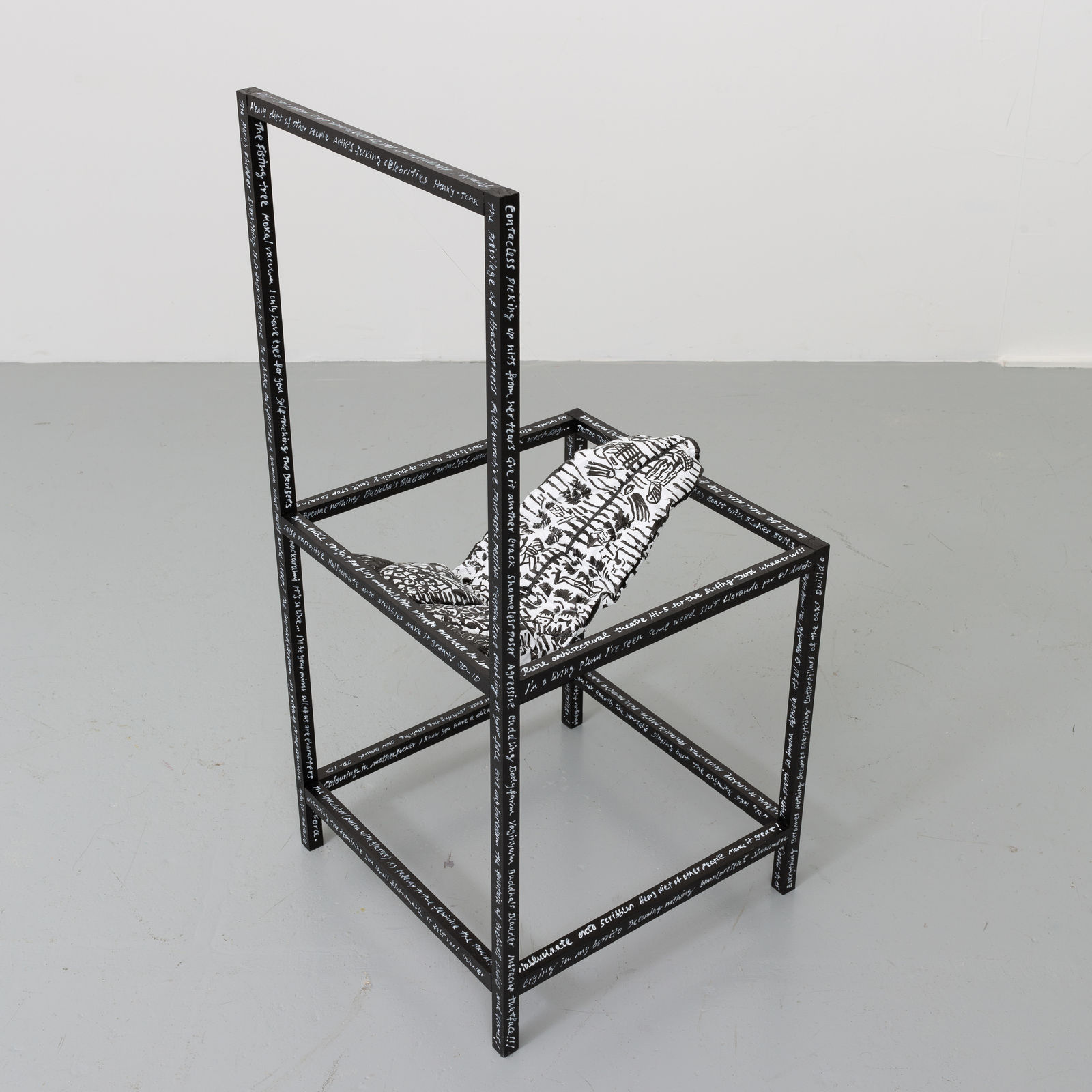 Black wooden chair with a soft sculpture tongue sticking out