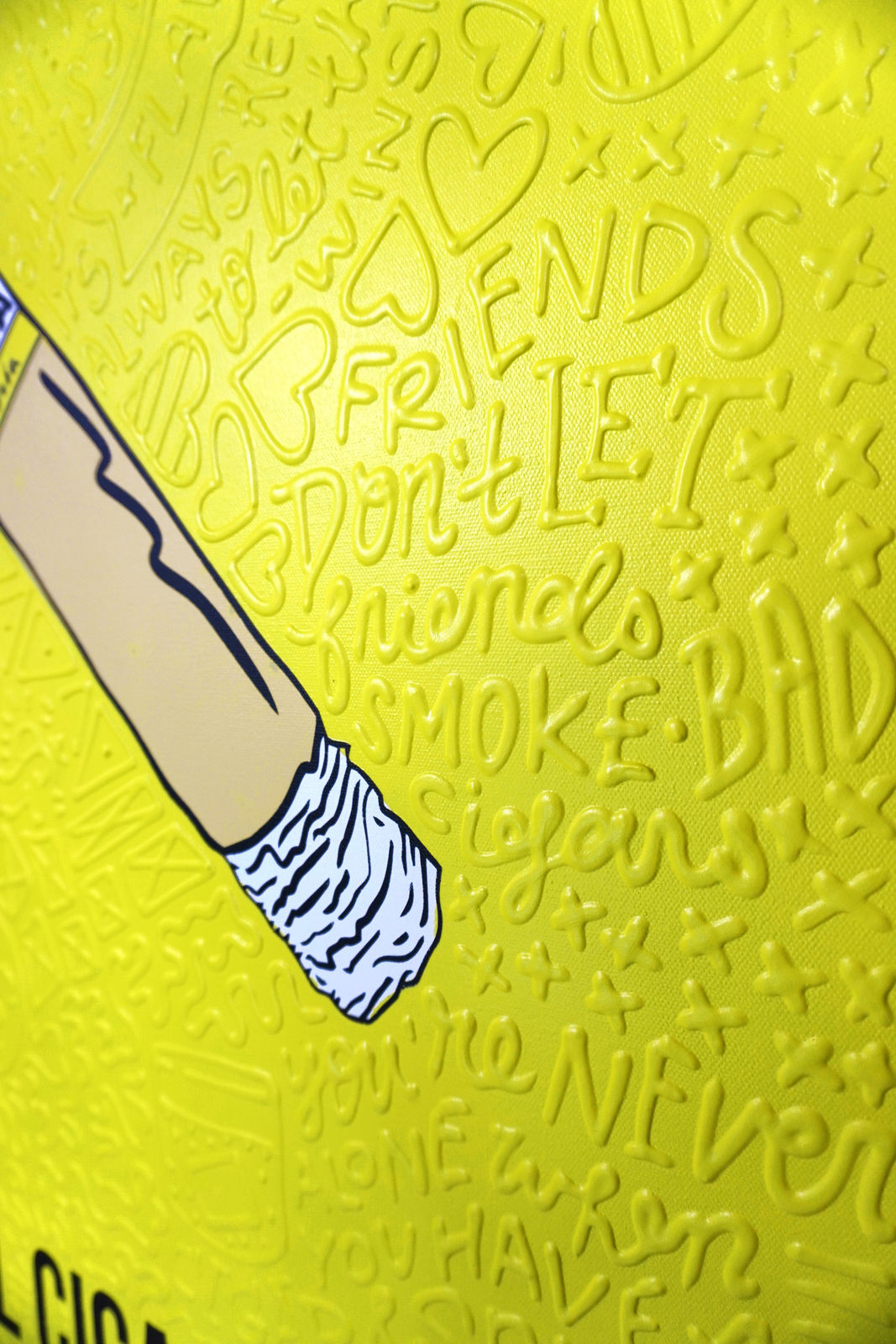 Detail photo of “El Cigarro”, painting by Cayla Birk artist from South Florida. Available at Carousel Fine Art Chicago. The artist’s technique blends traditional acrylic paints with unique materials, creating a distinct mixed media style. Birk's work is marked by intricate designs and recognizable gestures, combining contemporary culture, history, music, and literature. Her art challenges conventional thinking, offering new and unexpected experiences. Colors of this work : Yellow, Beige, White, Black