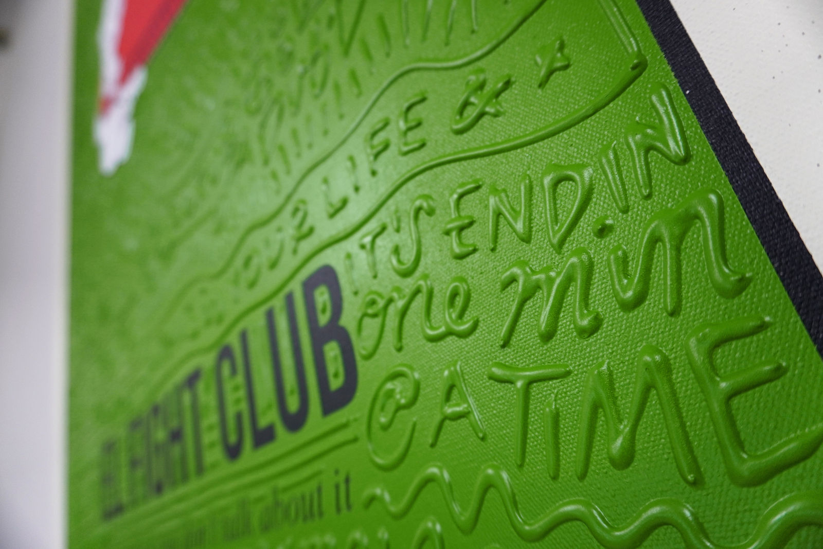 Detail photo of “El Fight Club”, painting by Cayla Birk artist from South Florida. Available at Carousel Fine Art Chicago. The artist’s technique blends traditional acrylic paints with unique materials, creating a distinct mixed media style. Birk's work is marked by intricate designs and recognizable gestures, combining contemporary culture, history, music, and literature. Her art challenges conventional thinking, offering new and unexpected experiences. Colors of this work : Green, Red, Beige, White, Black