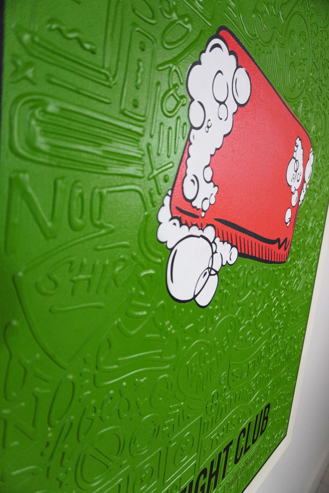 Detail photo of “El Fight Club”, painting by Cayla Birk artist from South Florida. Available at Carousel Fine Art Chicago. The artist’s technique blends traditional acrylic paints with unique materials, creating a distinct mixed media style. Birk's work is marked by intricate designs and recognizable gestures, combining contemporary culture, history, music, and literature. Her art challenges conventional thinking, offering new and unexpected experiences. Colors of this work : Green, Red, Beige, White, Black