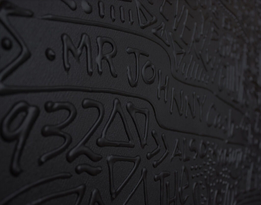 Detail photo of “Johnny Cash”, painting by Cayla Birk artist from South Florida. Available at Carousel Fine Art Miami. The artist’s technique blends acrylic, spray paint and silicone on canvas, creating a distinct mixed media style. Birk's work is marked by intricate designs and recognizable gestures, combining contemporary culture, history, music, and literature. Her art challenges conventional thinking, offering new and unexpected experiences. Colors of this work : White, Black