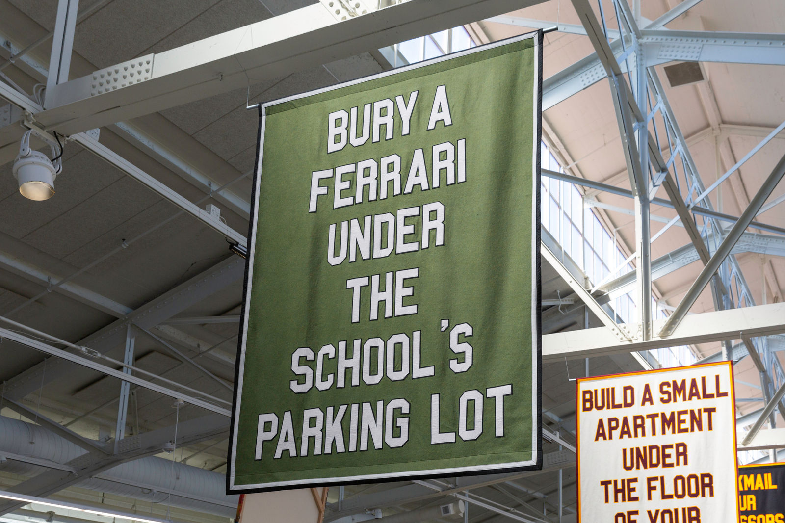 Jon Rubin, Bury a ferrari under the school's parking lot, in the series "Photograph Yourself Naked At Your Parents' House", 2018