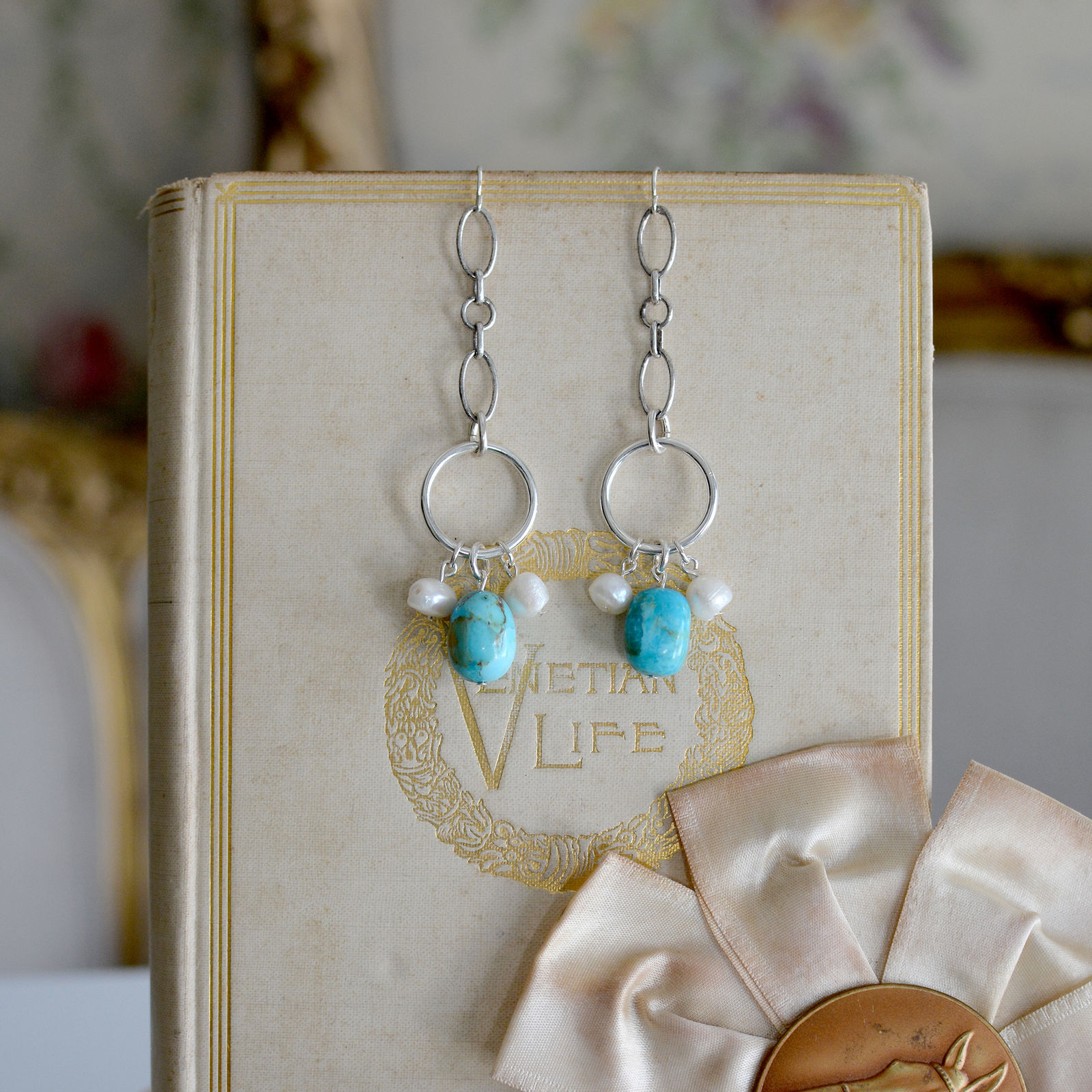 Jill Garber, Romantic long chandelier earrings crafted using Jill’s unique sterling silver link chaining with baroque freshwater pearls and large Kingman turquoise hand shaped beads