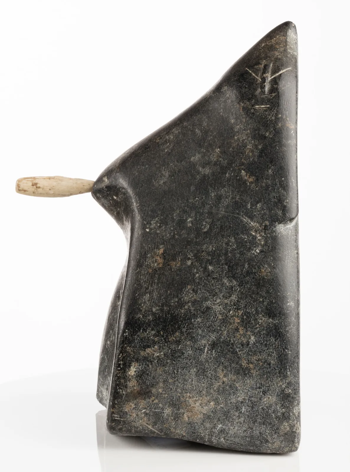 JOHN PANGNARK (1920-1980) ARVIAT (ESKIMO POINT), Figure Holding an Implement, c. 1972