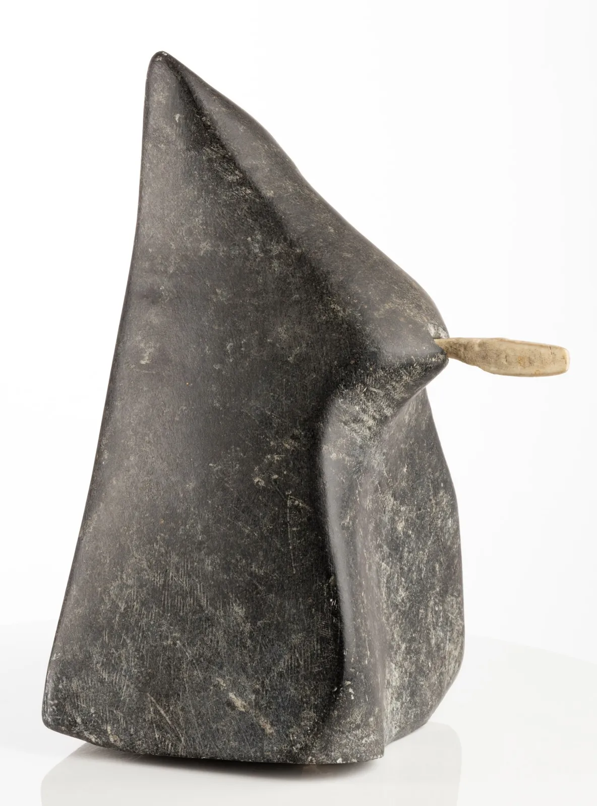 JOHN PANGNARK (1920-1980) ARVIAT (ESKIMO POINT), Figure Holding an Implement, c. 1972