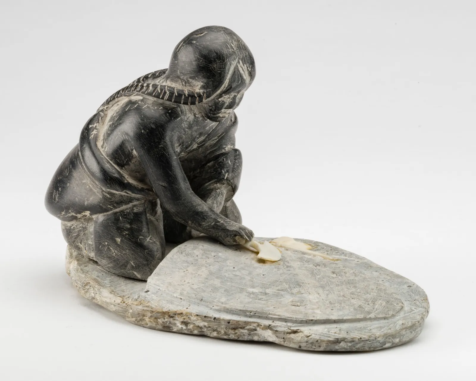 ENNUTSIAK (1893-1967) IQALUIT (FROBISHER BAY), Woman Preparing a Skin, c. late 1950s