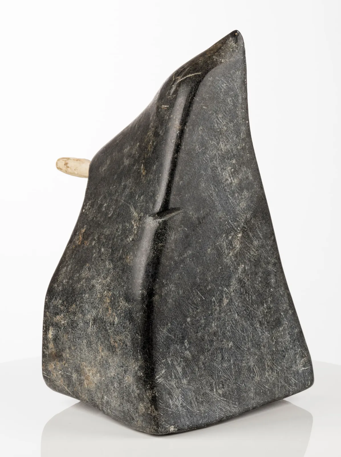 JOHN PANGNARK (1920-1980) ARVIAT (ESKIMO POINT), Figure Holding an Implement, c. 1972