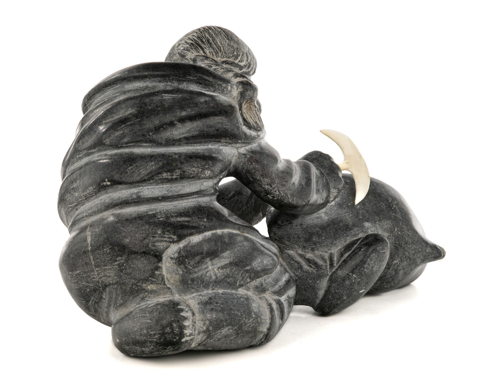 AUDLALUK KUPIRKRUALUK (1926-D) SALLUIT (SUGLUK), Woman Cutting Up an Avataq, early 1960s