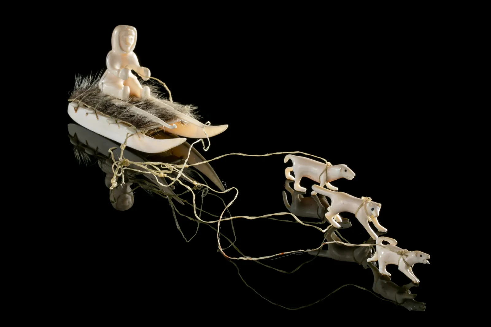 UNIDENTIFIED INUIT ARTIST, EASTERN CANADIAN ARCTIC, Hunter on Qamutiq (Sled) with Qimmiit (Sled Dogs), c. 1980