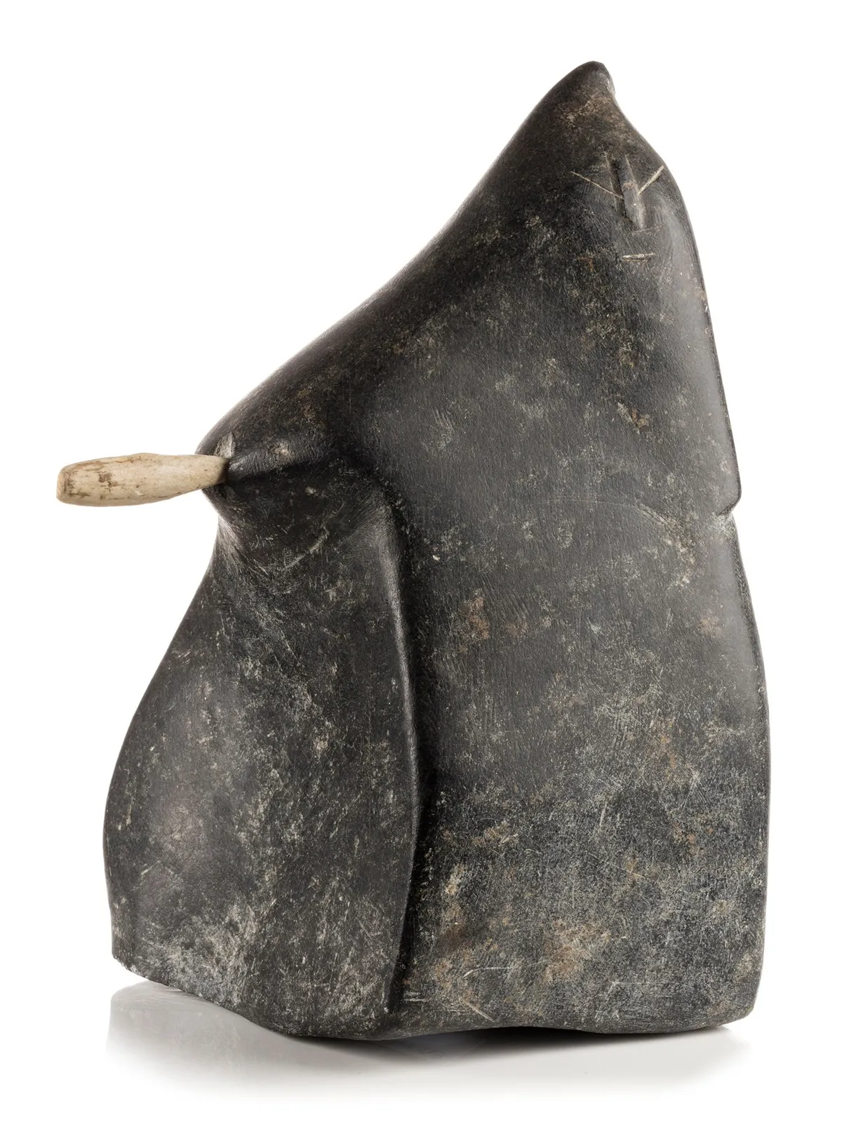 JOHN PANGNARK (1920-1980) ARVIAT (ESKIMO POINT), Figure Holding an Implement, c. 1972