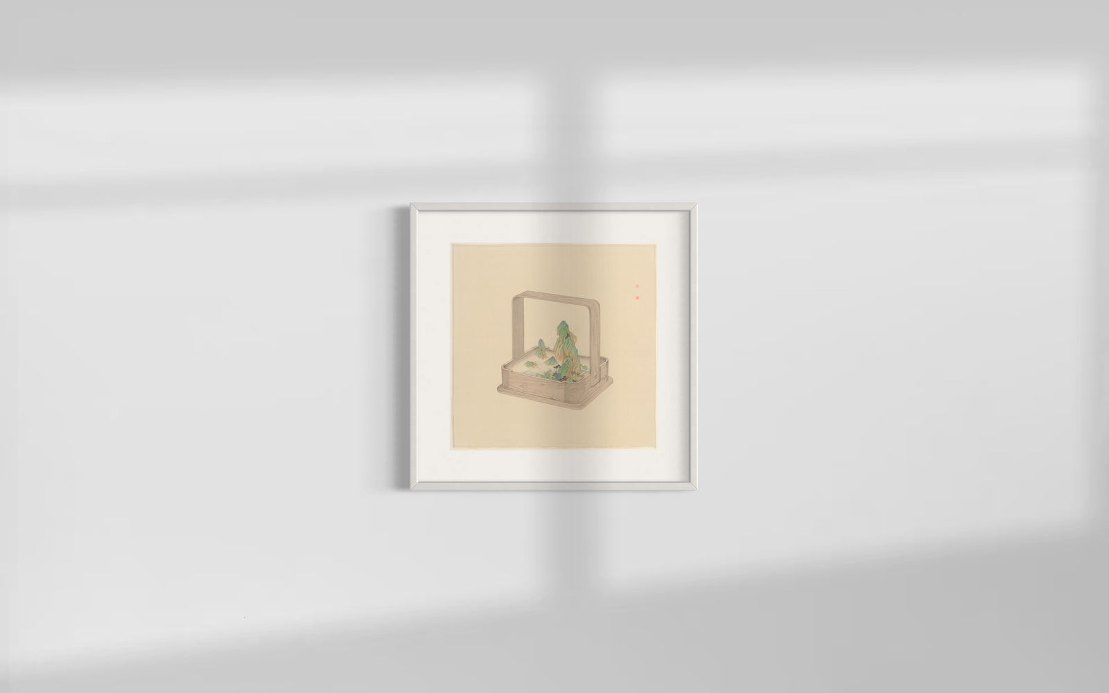 A framed picture that includes a basket with a mountain in it