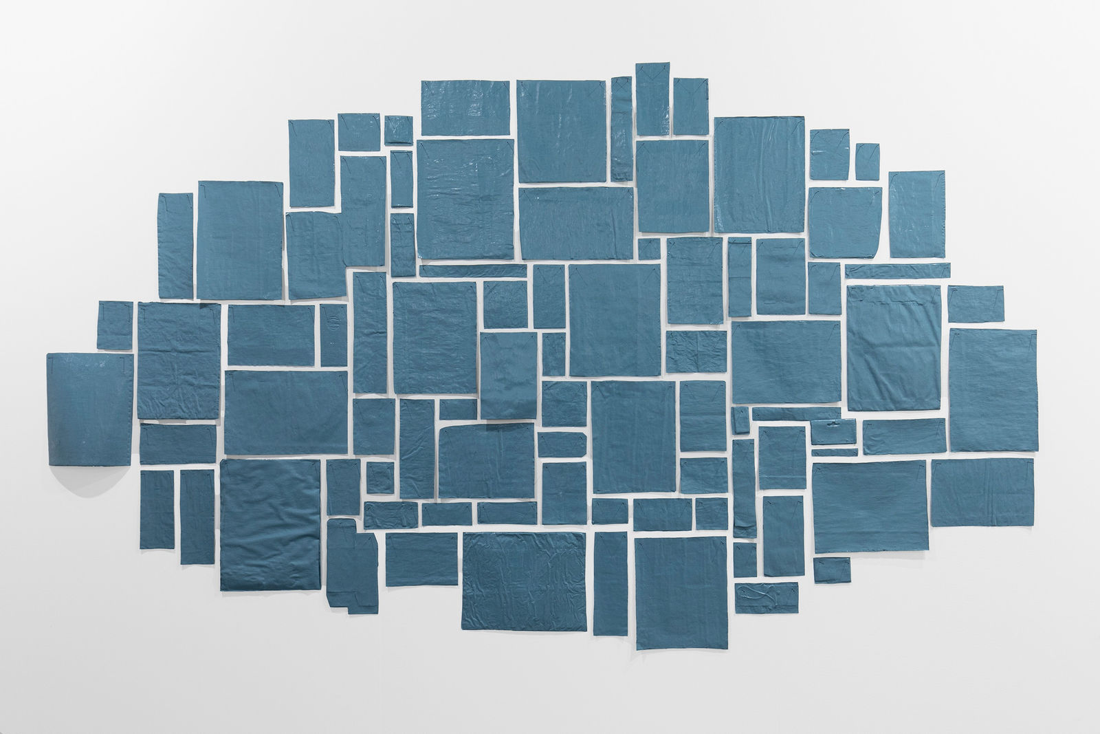 Abraham Cruzvillegas, An exhausted but happy blind self portrait reading 'A life', a Piet Mondrian biography by Hans Janssen, while listening to 'Feeling Good' by the enormous Nina Simone, having a little strawberry KitKat bar and having the fourth espresso of the morning, trying to understand properly all changes to the law and justice system changes, 2024