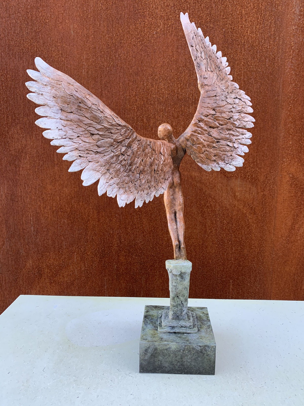 Bronze sculpture of mythical Greek winged figure Icarus by Nicola Godden, displayed on integral plinth