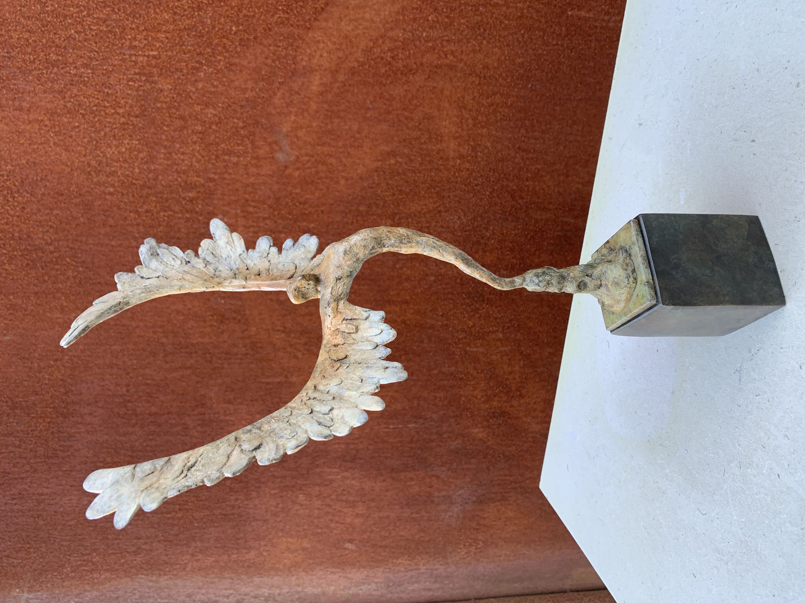 Bronze sculpture of mythical Greek winged figure Icarus by Nicola Godden, displayed on plinth